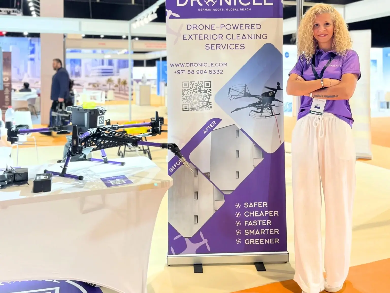 DRONICLE exhibitor at VertiExpo Dubai 2025 showcasing drone-powered exterior cleaning services with a drone on display.