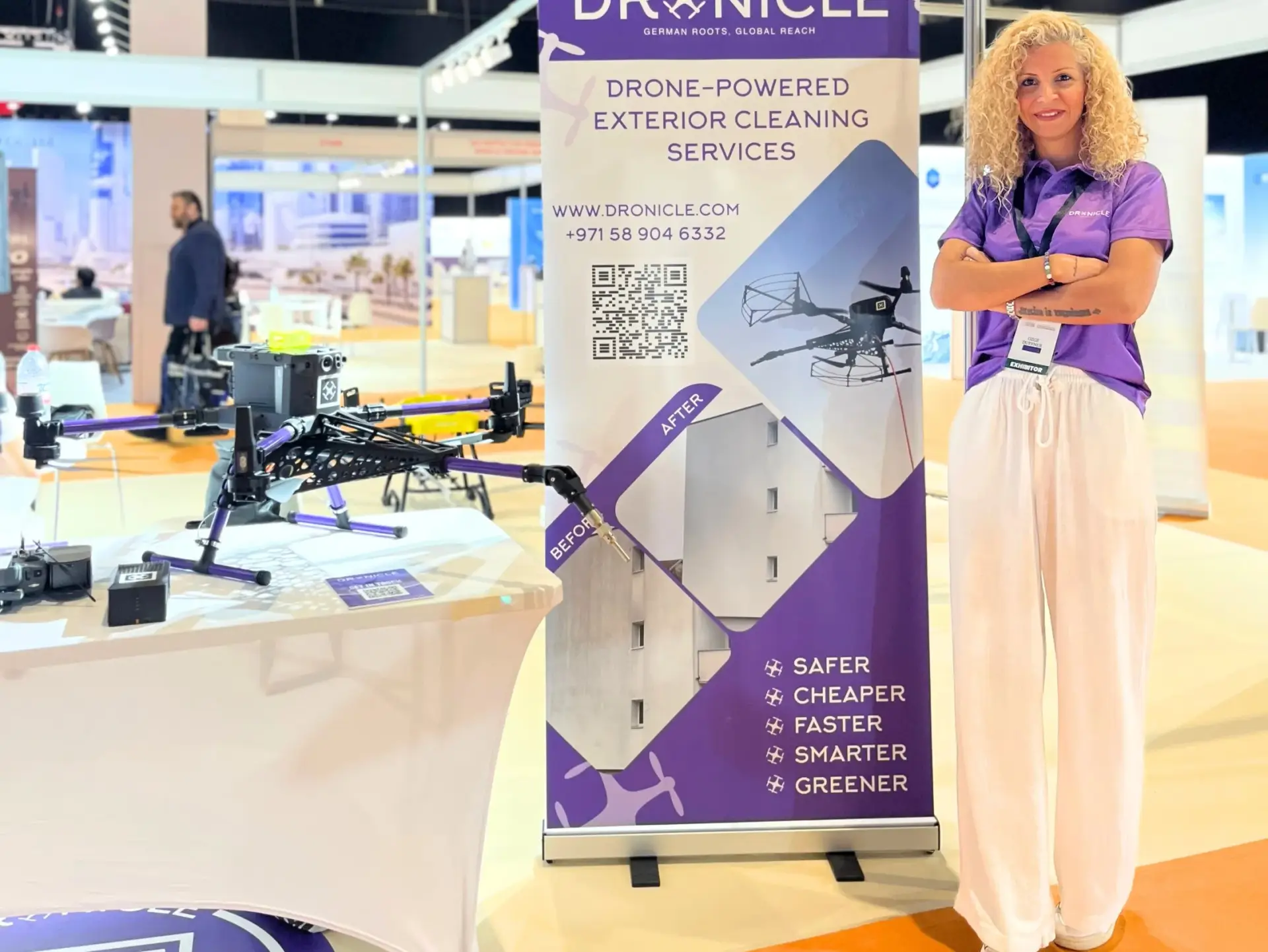 DRONICLE exhibitor at VertiExpo Dubai 2025 showcasing drone-powered exterior cleaning services with a drone on display.
