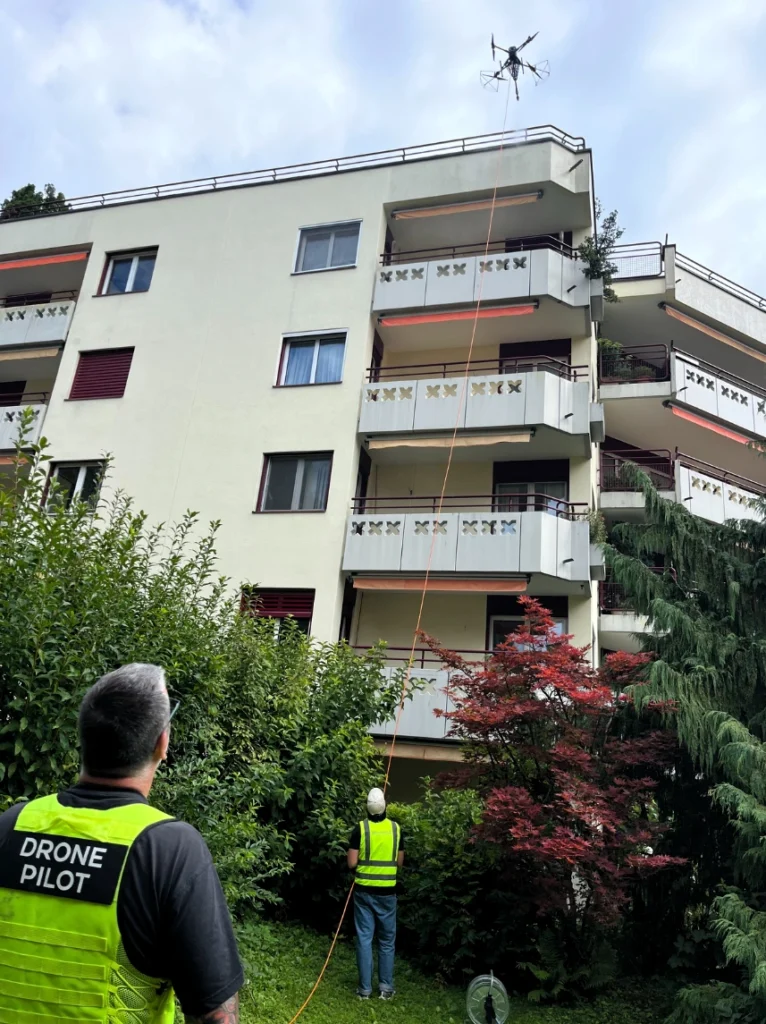 Drone Cleaning on a apartment building with the pilot in the foreground.