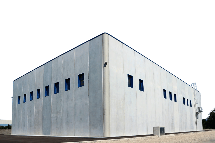 Exterior of a modern industrial building with gray concrete panels and small blue windows.