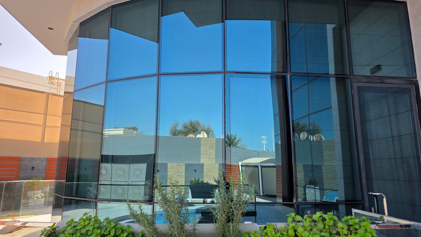Rounded glass wall perfectly cleaned by DRONICLE's team in Al Barsha. The windows look brand new.