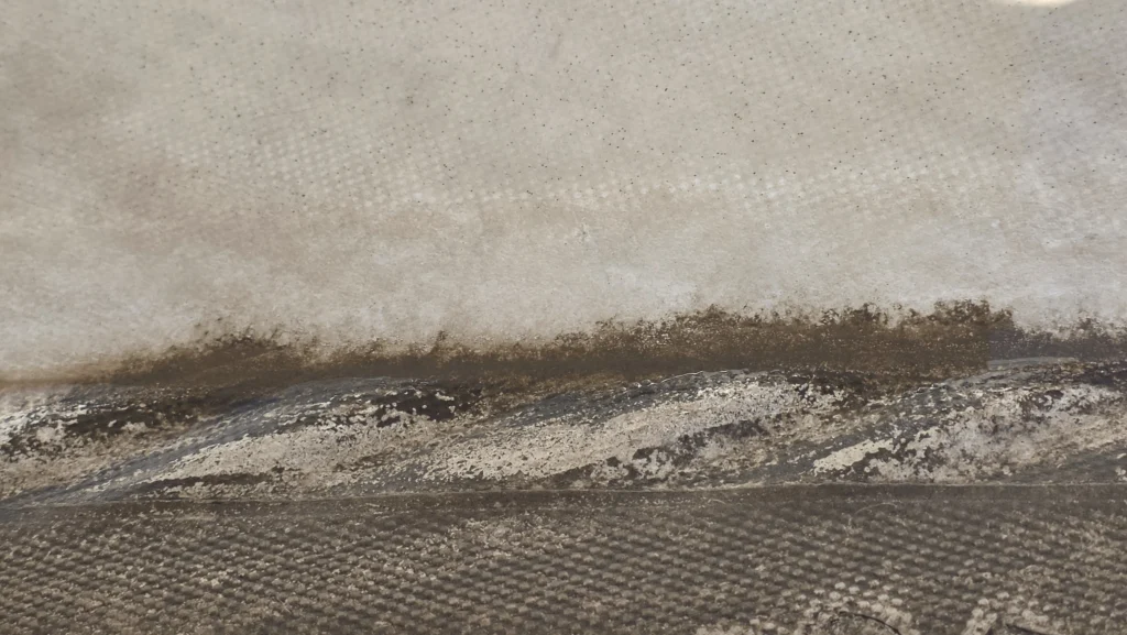 DRONICLE’s advanced drone technology in action: Close-up picture of a playground shade canopy before and after canopy drone cleaning, highlighting the eco-friendly removal of dirt and stains for a refreshed outdoor space.